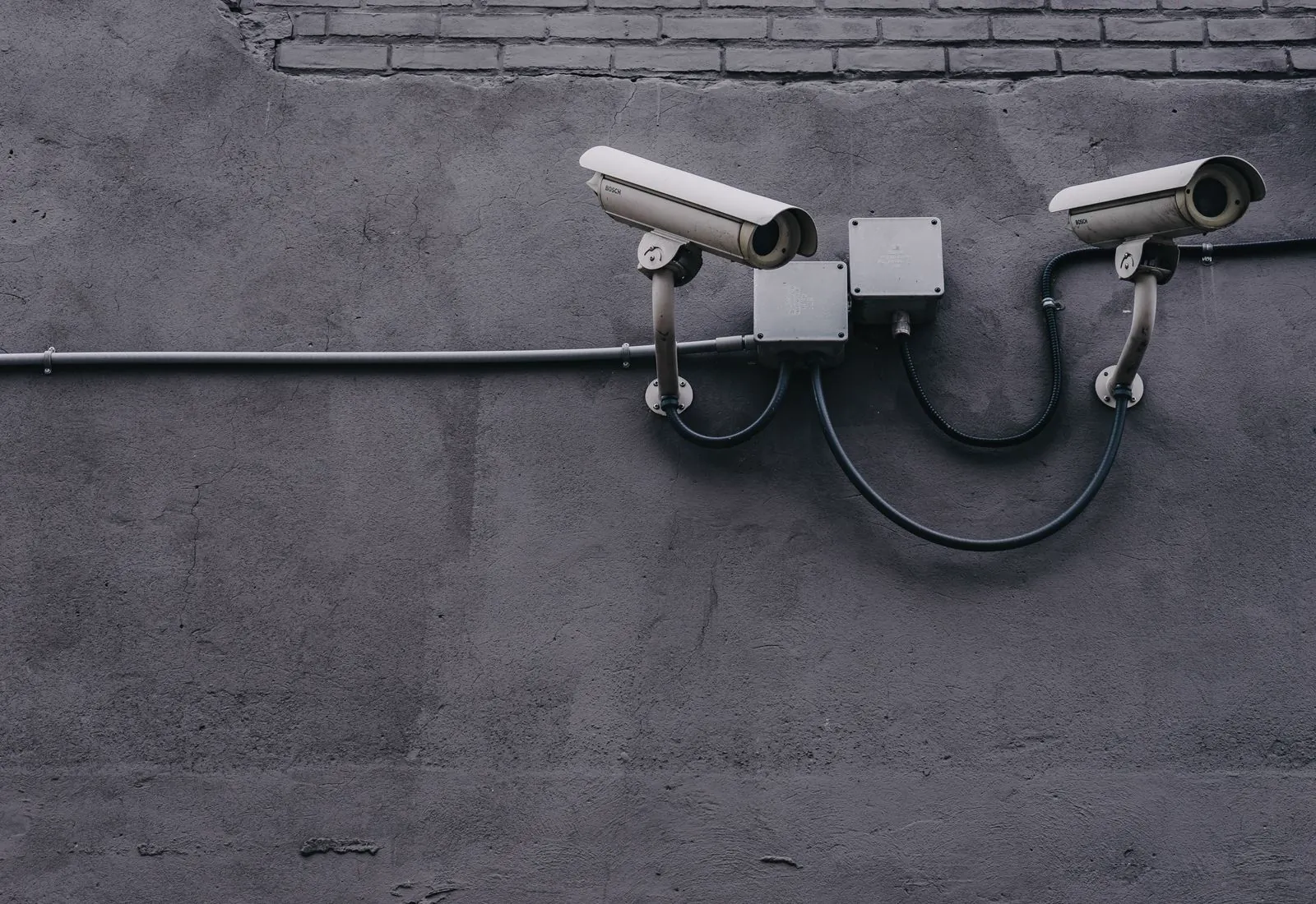 Surveillance cameras mounted on a pole monitoring an industrial site
