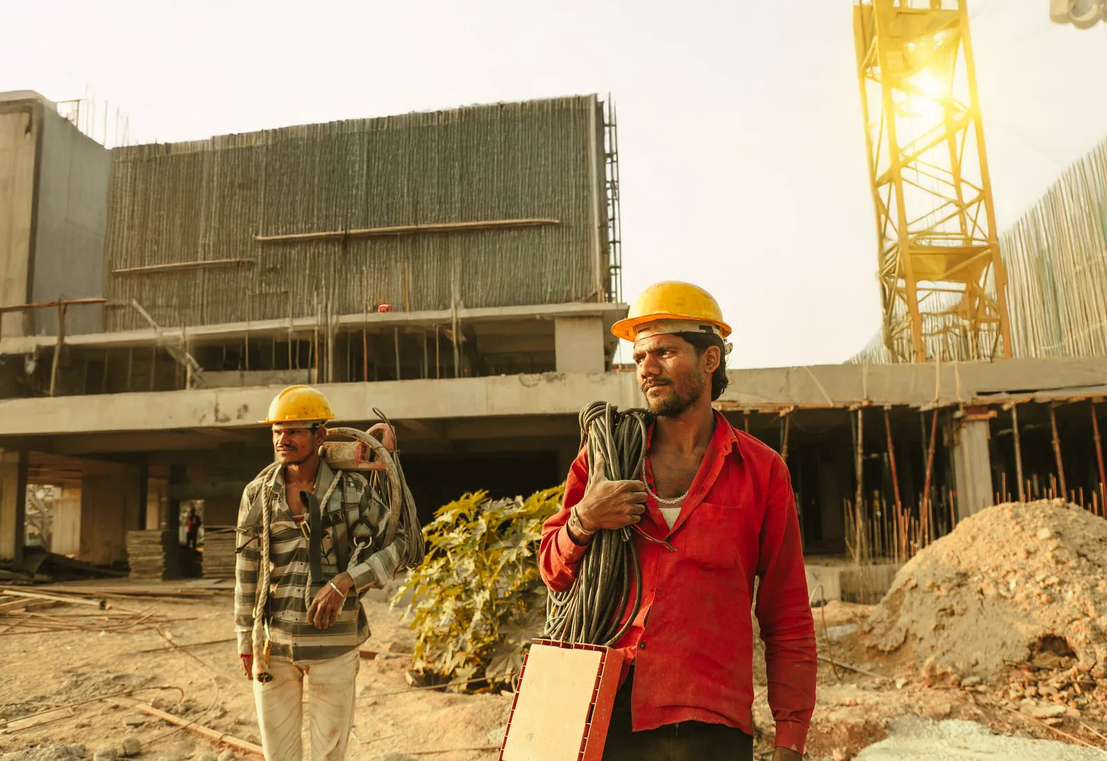 Industrial workers in protective equipment operating heavy machinery