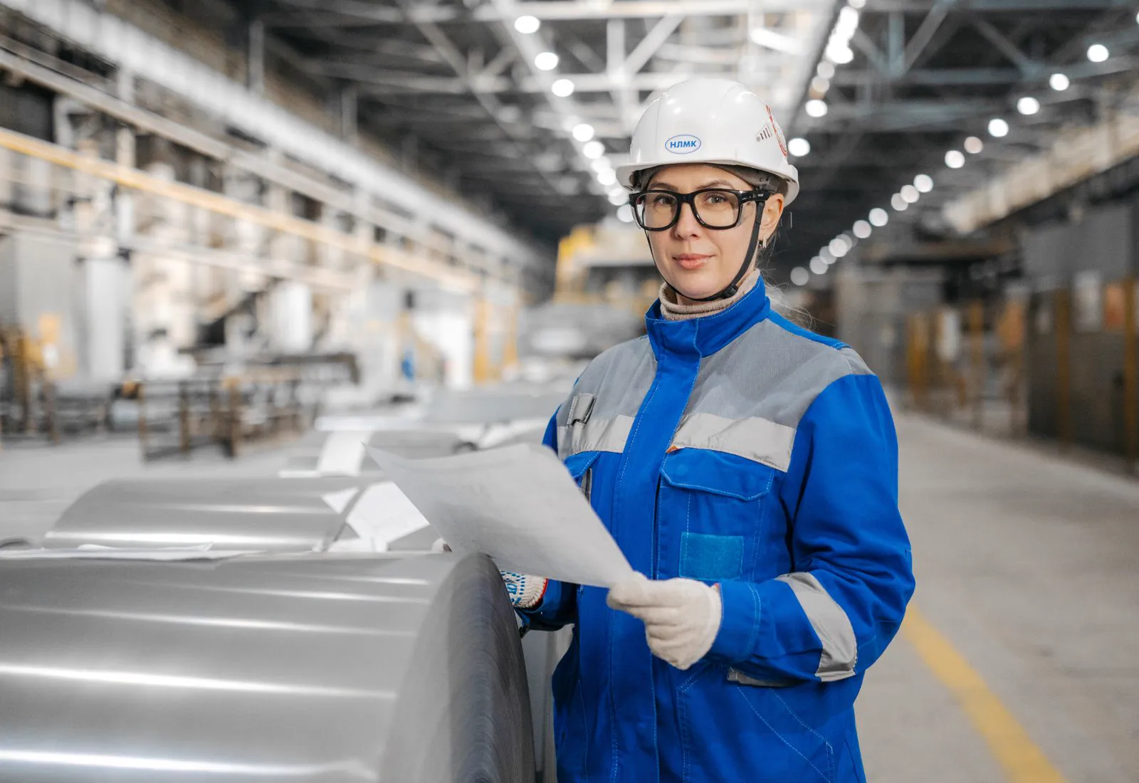 Industrial worker in hard hat and high-visibility safety gear on site